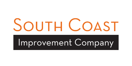 Logo for South Coast Improvement Company with orange text above white text on a black rectangular background.