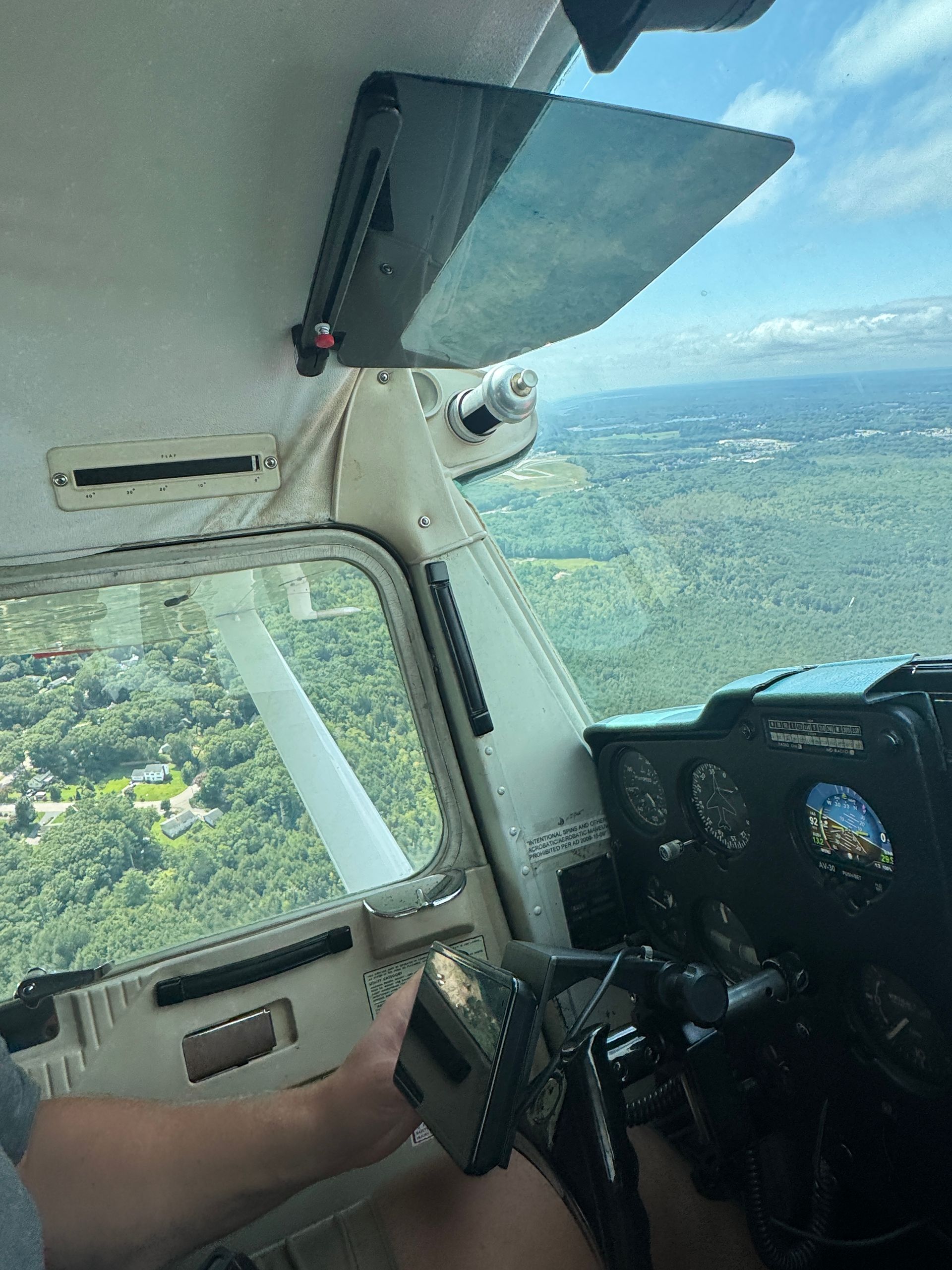 Student pilot reviewing tablet at a desk inside a small airport FBO