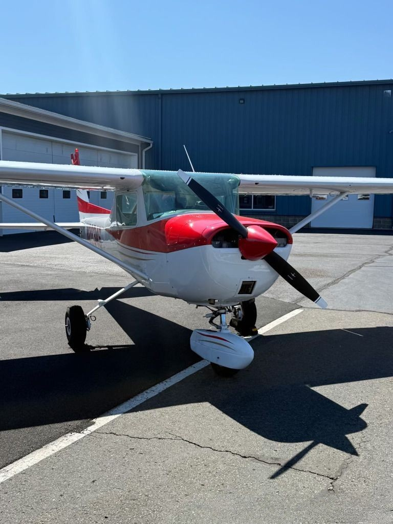 Cessna 150 parked on the ramp at Westerly State Airport on a clear morning