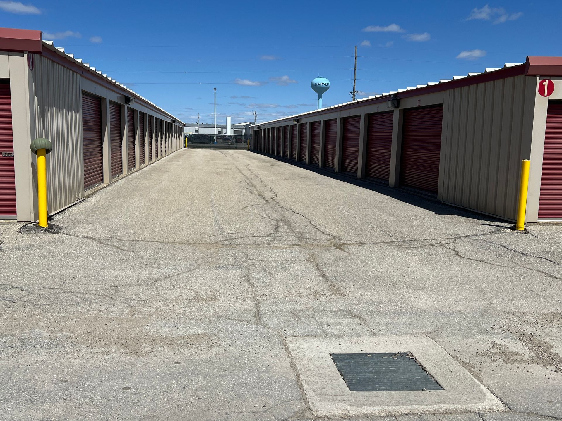 A row of storage units with yellow doors on a sunny day.
