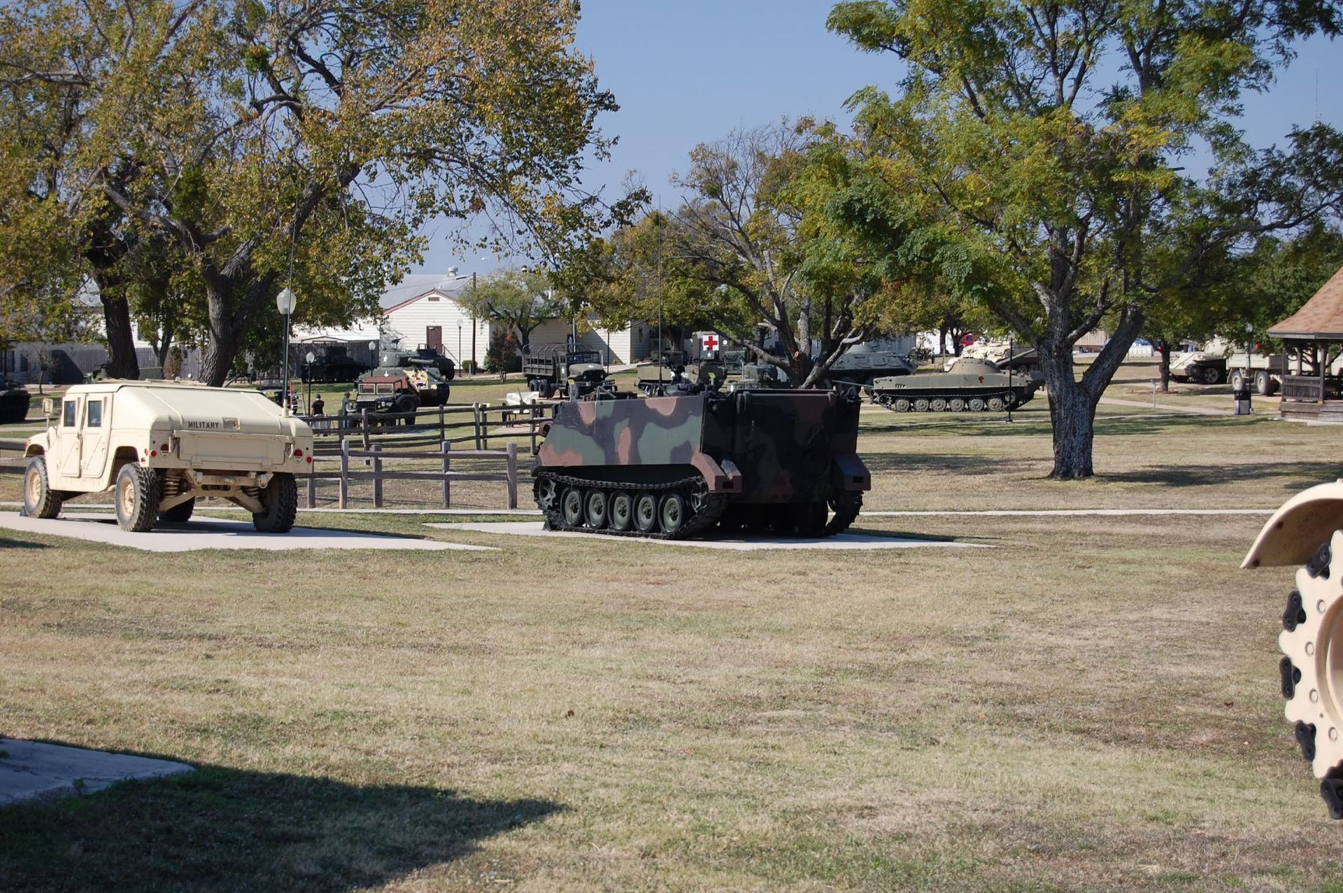 A military vehicle is parked in a grassy field