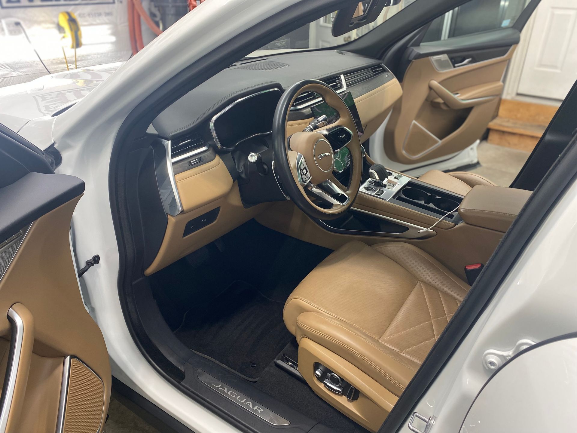 Interior view of a Chrysler Pacifica minivan, showing the dashboard, seats, and center console.