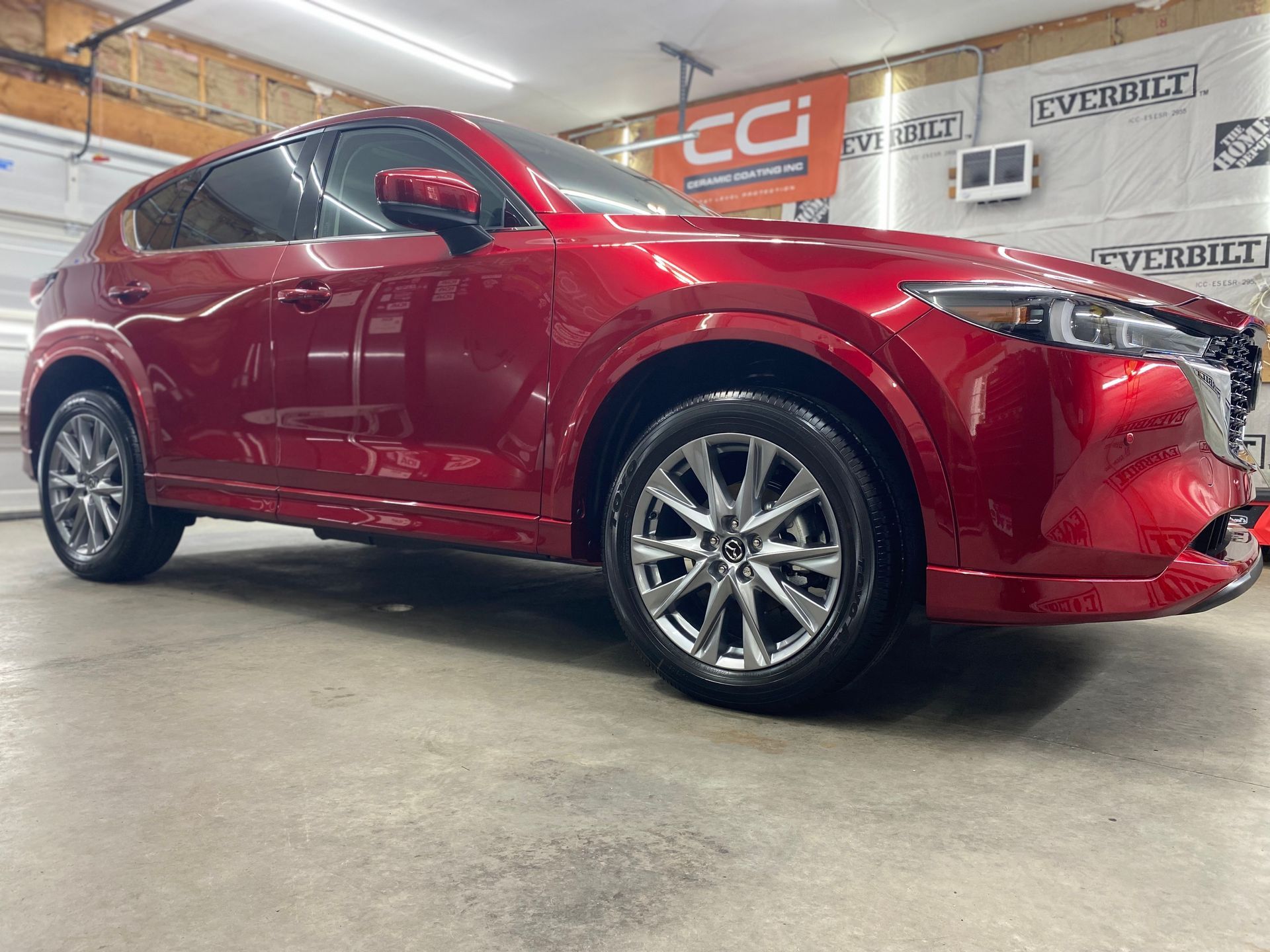 Red Mazda CX-5 SUV in a garage with a shiny, clean appearance.