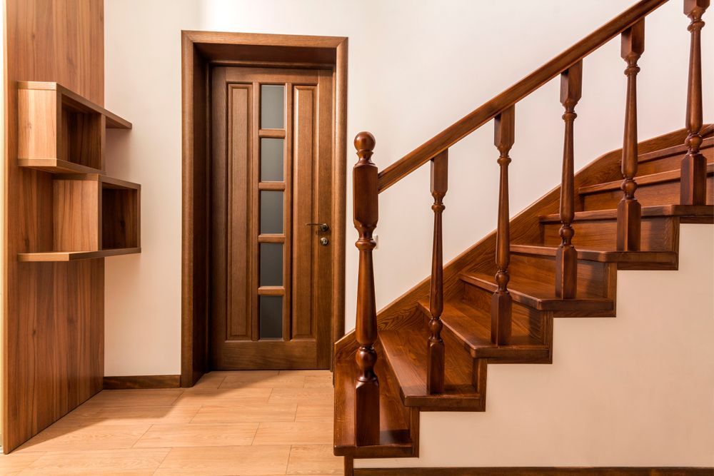 A Wooden Staircase With A Wooden Railing And A Wooden Door — Roo’s Door & Window Maintenance In Sippy Downs, QLD