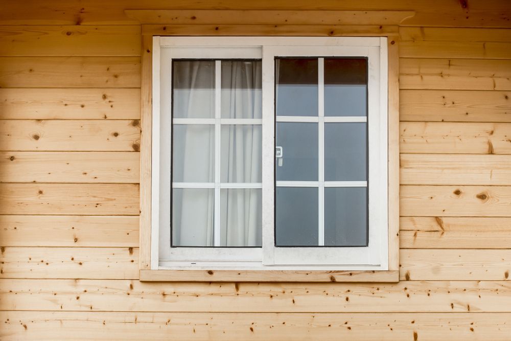 A White Window On A Wooden Wall Of A House — Roo’s Door & Window Maintenance In Sippy Downs, QLD