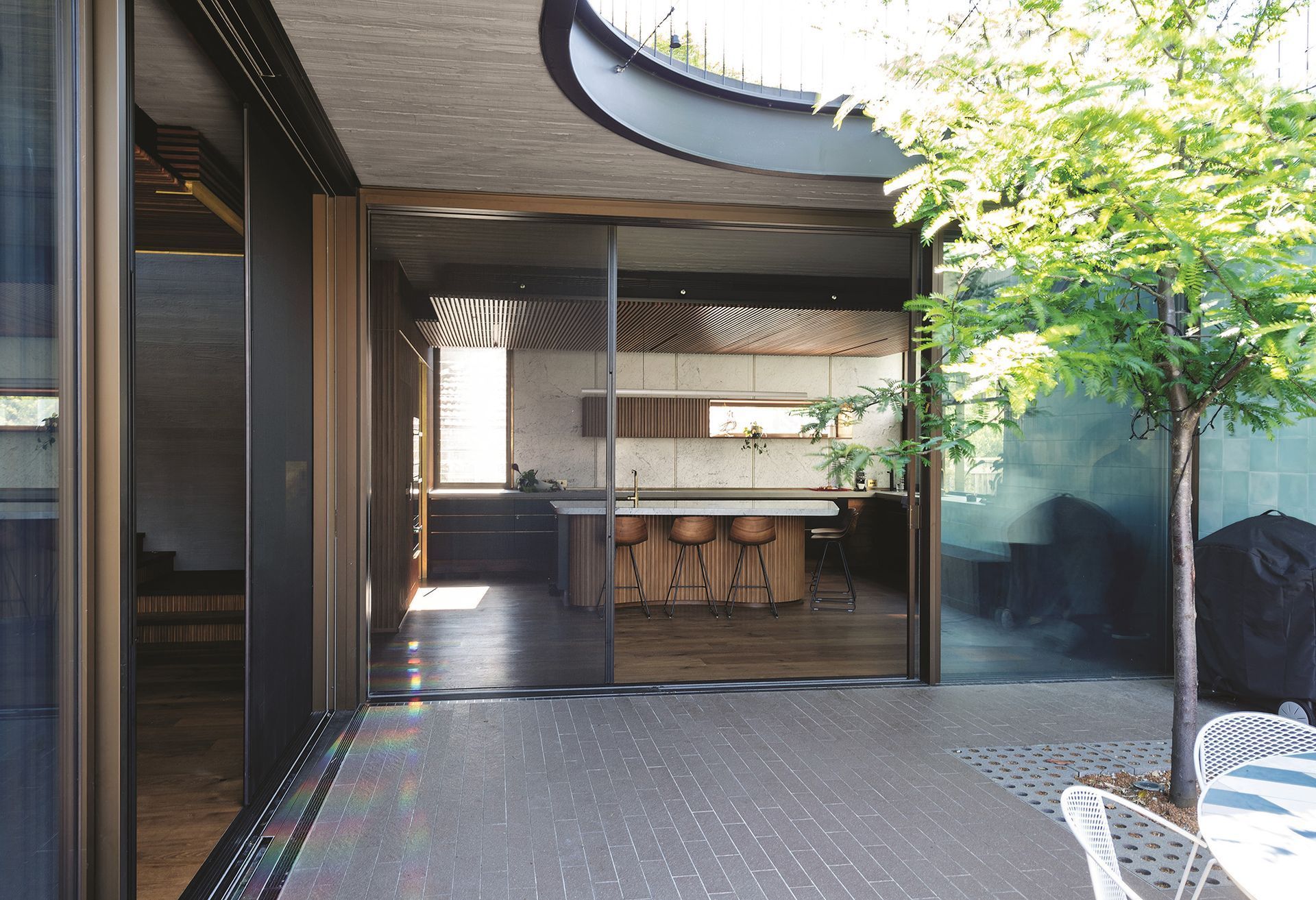 A View Of A Kitchen Through A Sliding Glass Door — Roo’s Door & Window Maintenance In Sippy Downs, QLD