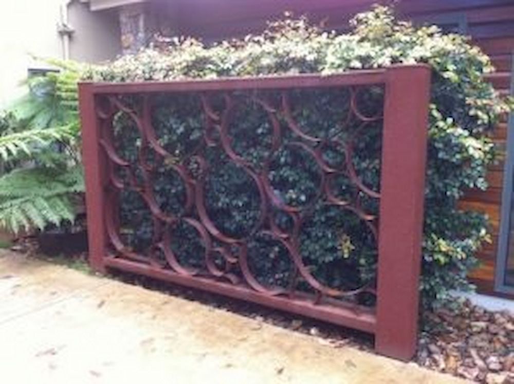 A Wooden Fence With a Pattern on It is Surrounded by Plants — Metaltrendz in Kunda Park, QLD