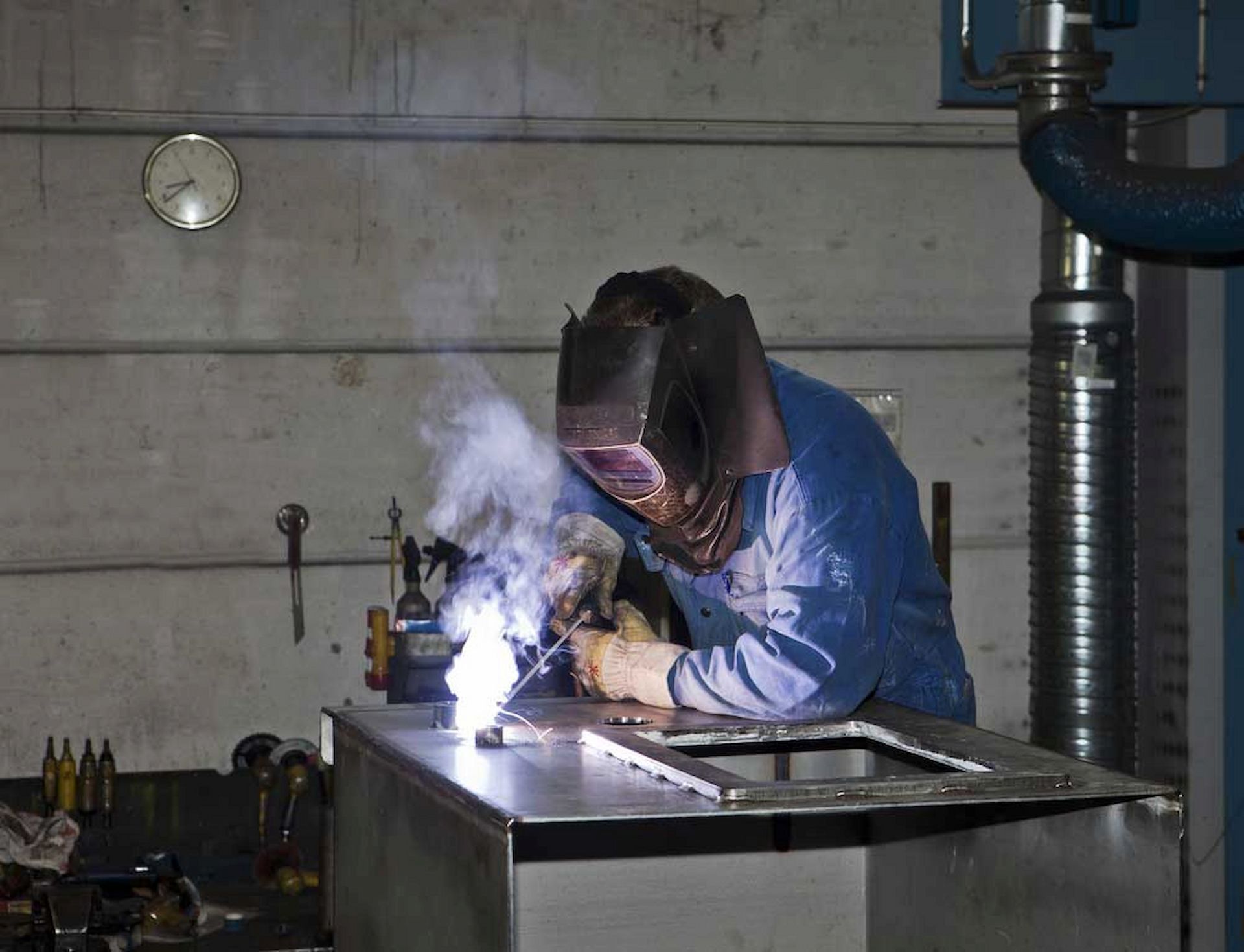 A Man Wearing a Welding Mask is Welding a Piece of Metal — Metaltrendz in Kunda Park, QLD