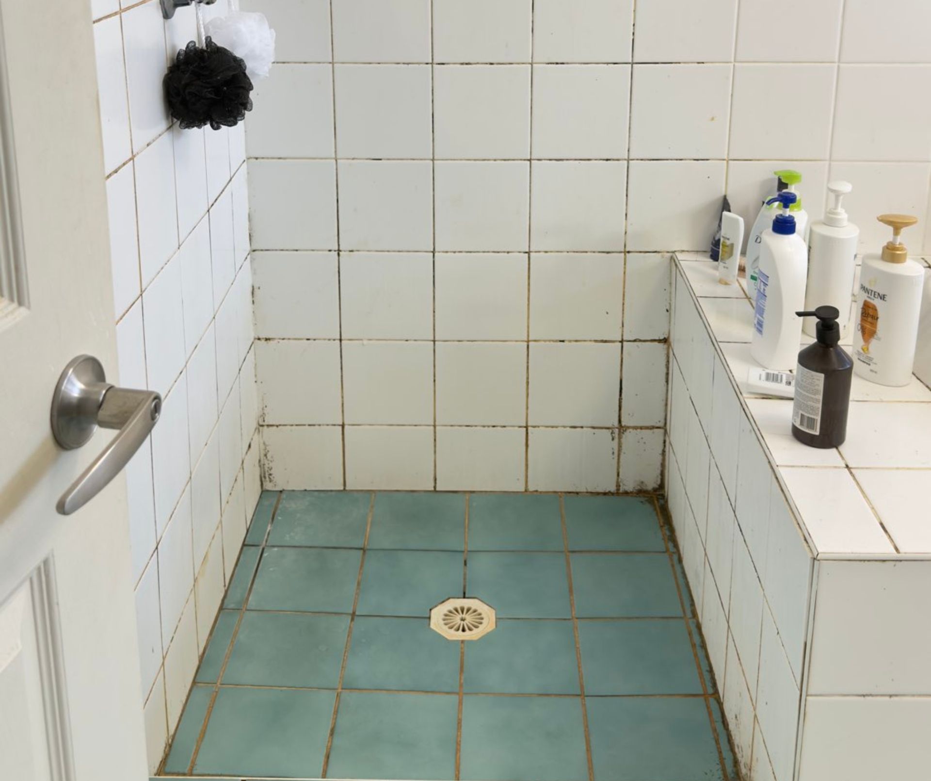 Bathroom with Dirty White Tiles on Wall and Blue Tiles on Floor — Schmucker Cleaning in Gulliver, QLD