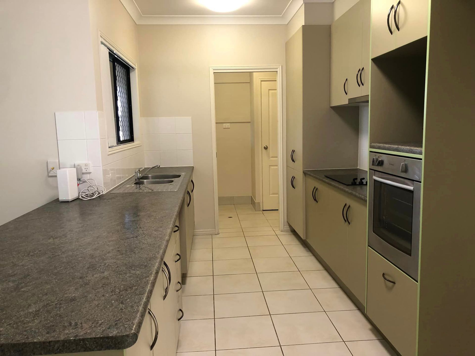 A Clean Kitchen with A Sink and Cupboards — Schmucker Cleaning in Gulliver, QLD