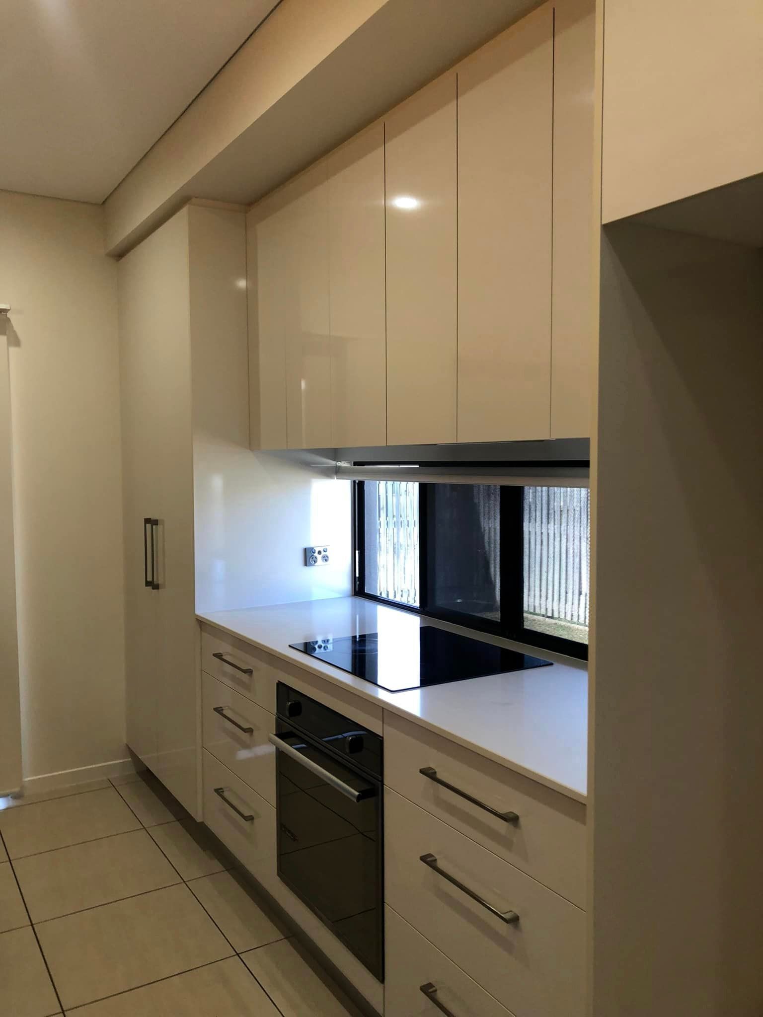 A Kitchen with An Electric Cook Top, Oven and Cupboards — Schmucker Cleaning in Gulliver, QLD