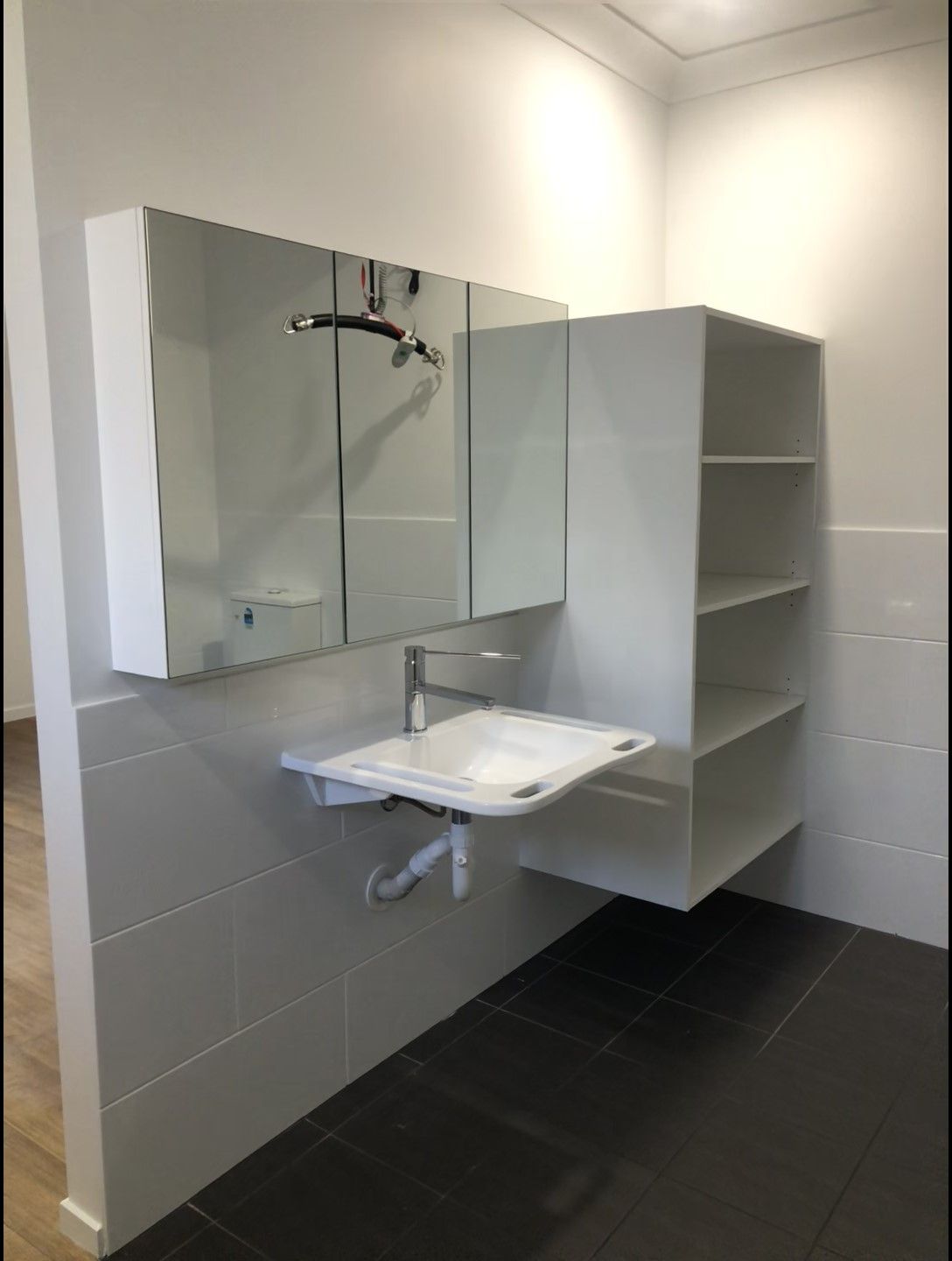 A Bathroom Sink With a Faucet and a Mirror — Schmucker Cleaning in Gulliver, QLD