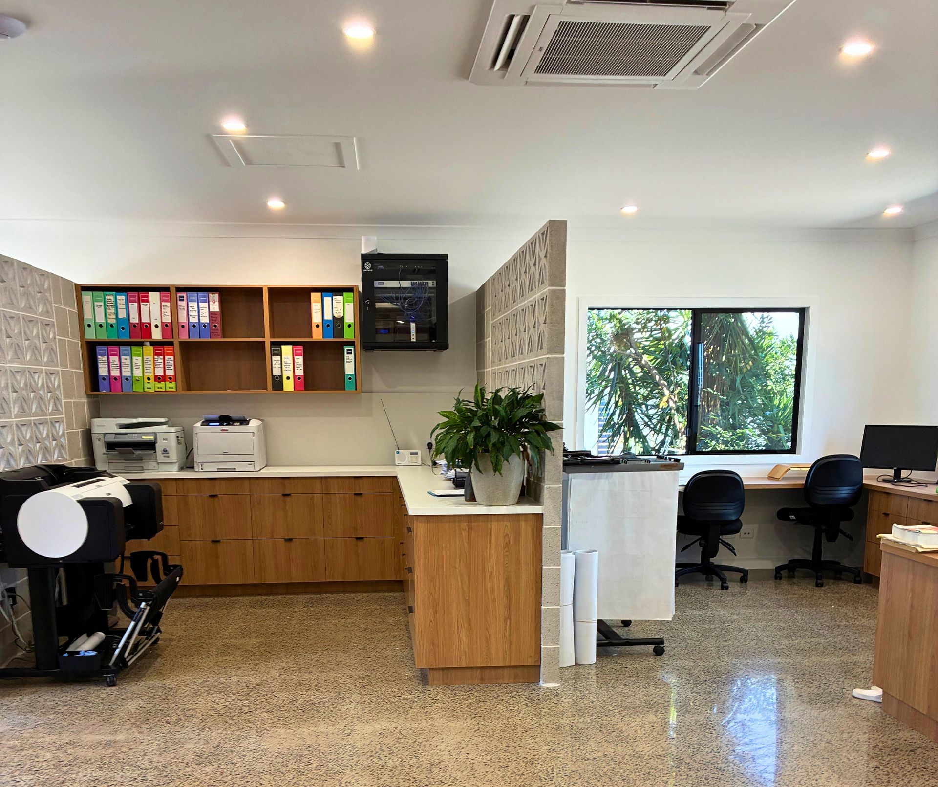 A Large Building With a Lot of Windows is Sitting on Top of a Lush Green Field — Schmucker Cleaning in Gulliver, QLD