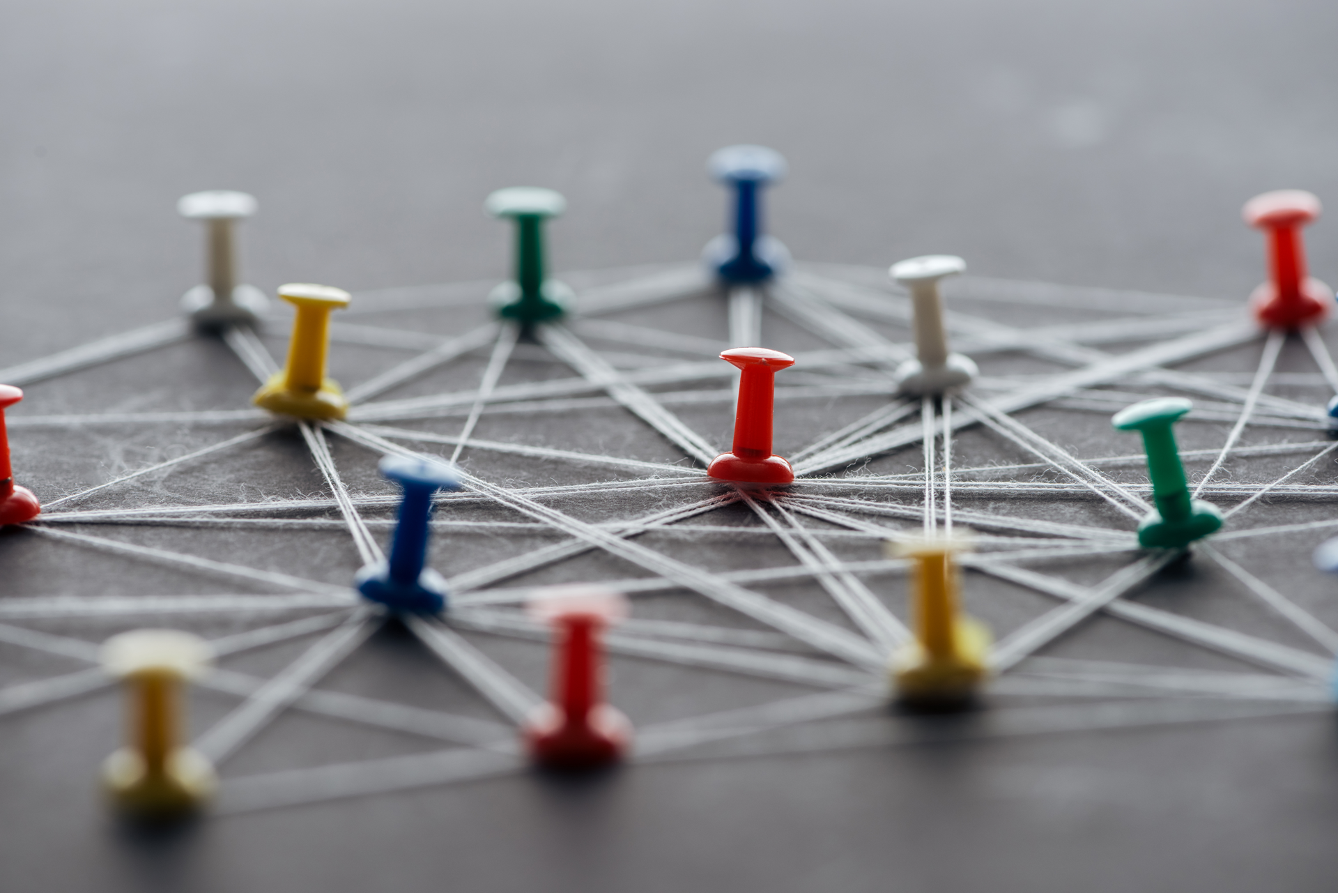 A bunch of colorful pins are connected to each other on a table.