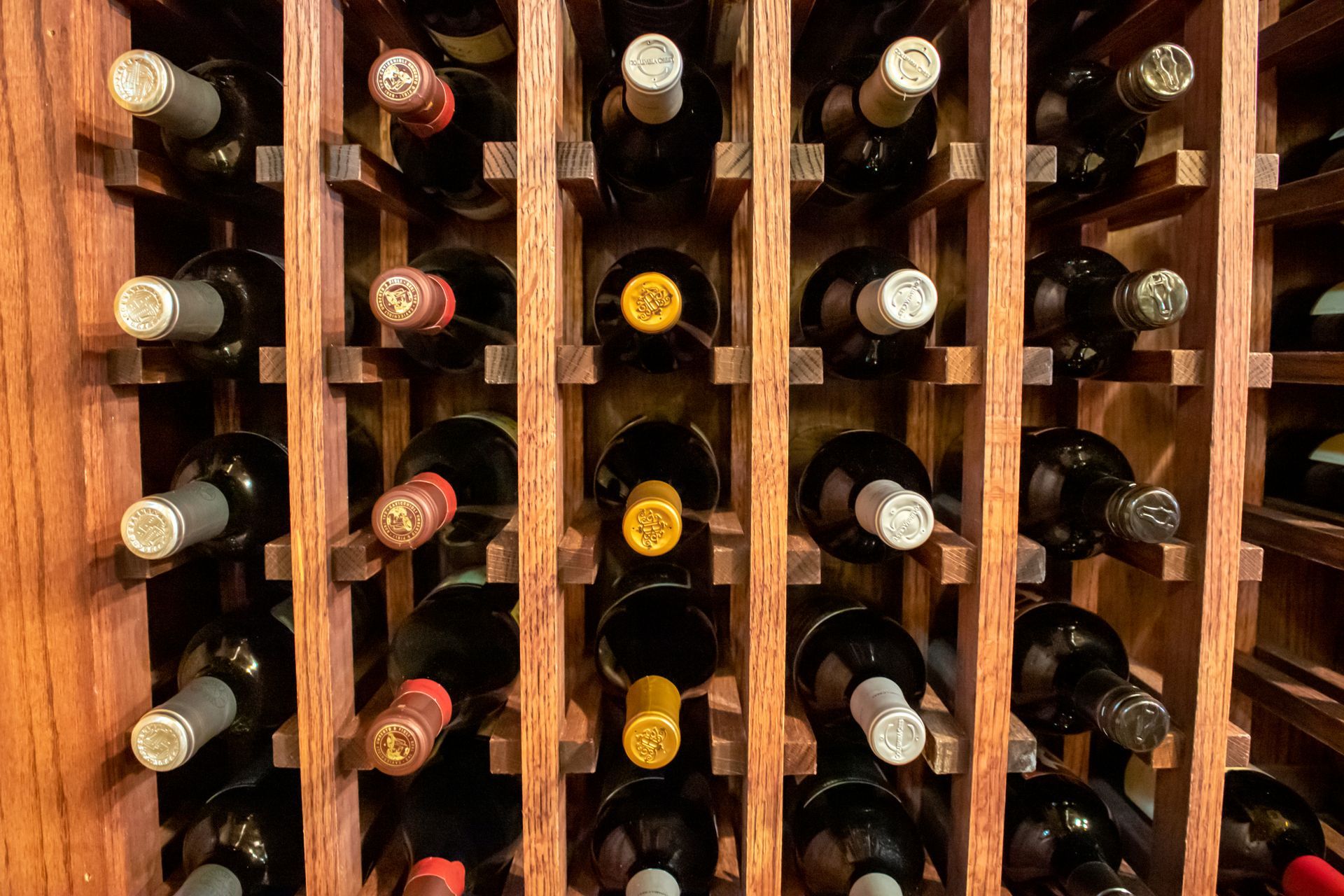 A wooden wine rack filled with bottles of wine.