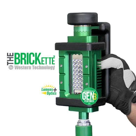 Green BRICKETTE GEN3 moisture meter with black handle and white-gloved hand on white background