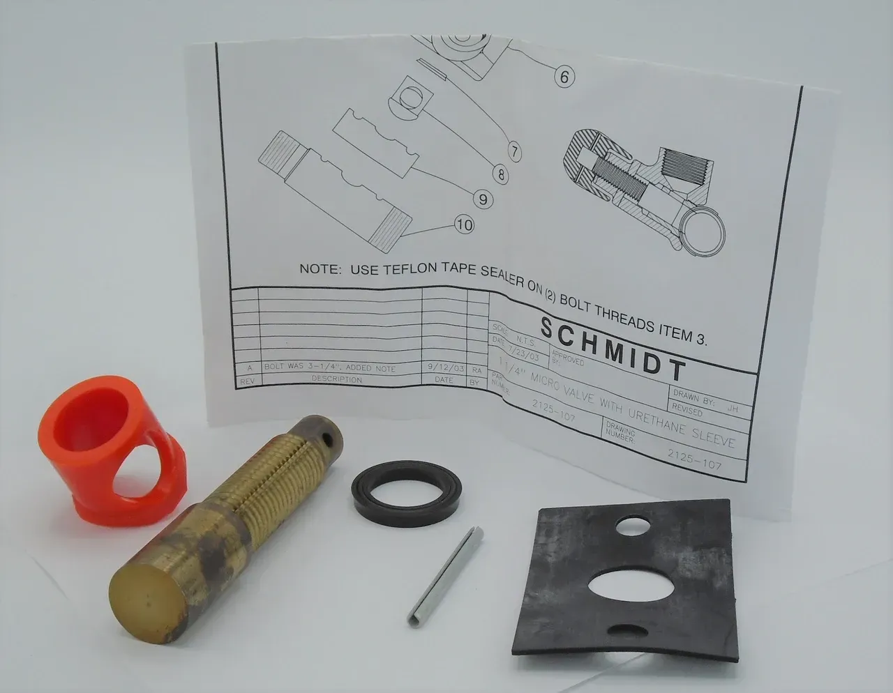 Assorted hardware parts and a product instruction sheet on a white surface