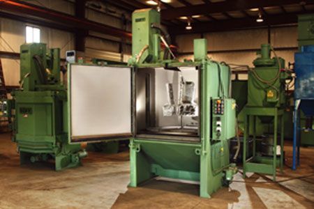 Open industrial oven with hinged door, control panel, and stainless steel chamber.