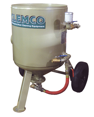 Beige industrial sandblaster tank on wheels with hoses and pressure gauge