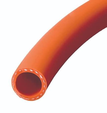 Orange flexible rubber hose close-up against a white background