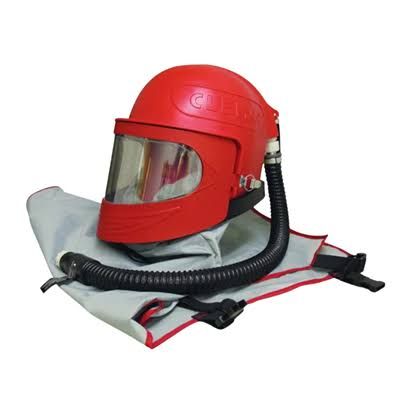 Red full-face respirator with clear visor and hose on folded gray carrying bag