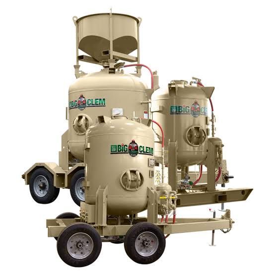 Beige industrial air filtration units on a trailer-mounted wheeled frame with hoses and tanks
