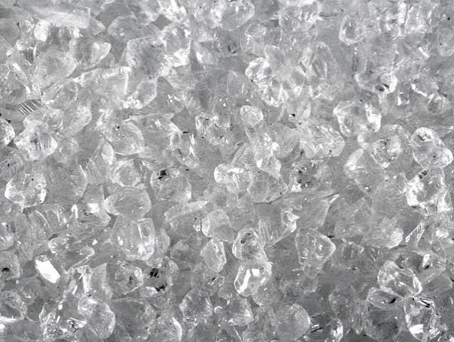 Close-up of clear ice or crushed glass crystals forming a textured surface