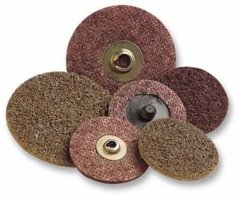 A stack of maroon and brown abrasive sanding discs with center holes.