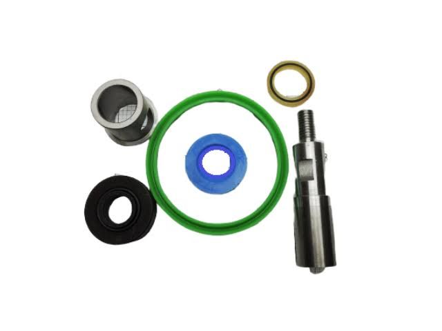 Assorted rubber O-rings, gaskets, and metal valve parts on a white background