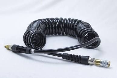 Coiled black air hose with metal fittings on a white background