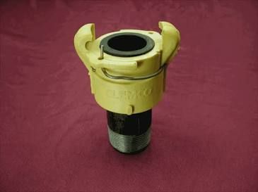 Yellow and black industrial hose coupling on a maroon fabric background