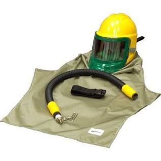Yellow hard hat with green face shield and hose laid on a folded protective suit, safety gear set