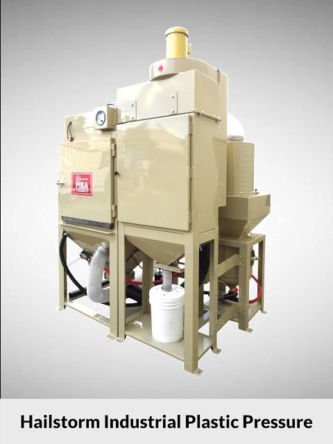 Beige industrial plastic pressure machine with pipes and tank on a metal frame against a white background