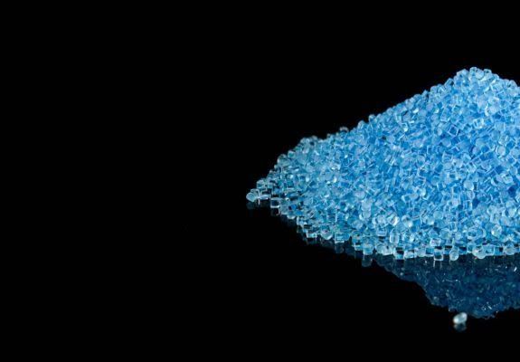 Blue crystalline sugar pile on a black background