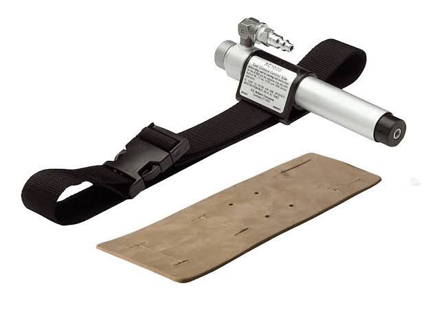 Portable metal tool with black strap and tan instruction card on white background