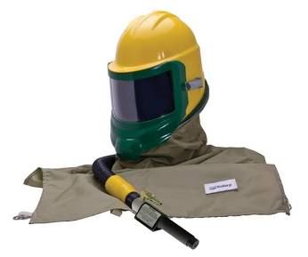 Yellow hard hat face shield, protective hood, and glove with a black-and-yellow tool on beige background
