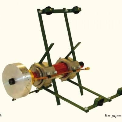 Mechanical rotary apparatus with metal frame, red central cylinder, and silver disc on one end