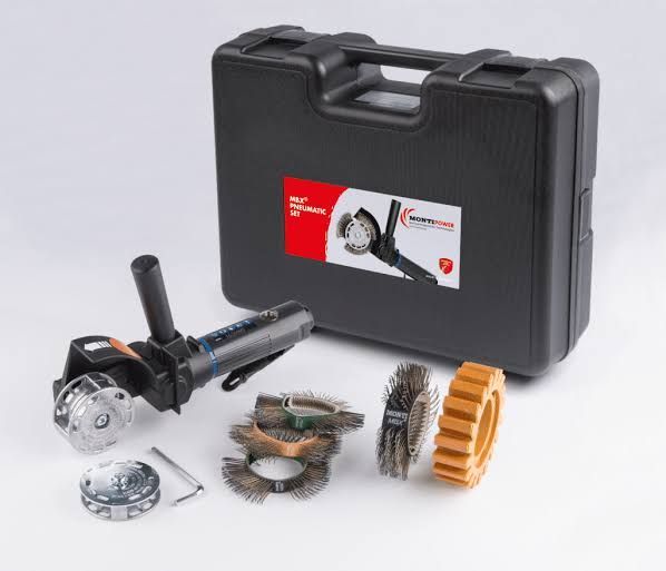 Black carrying case with angle grinder and assorted cutting and sanding discs laid out on white background