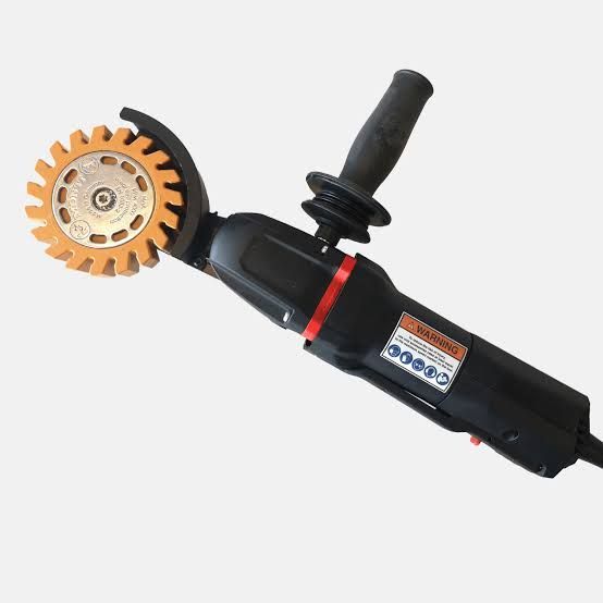 Black angle grinder with orange cutting wheel and side handle on a white background