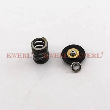 Two small black and silver mechanical spring parts on a white background