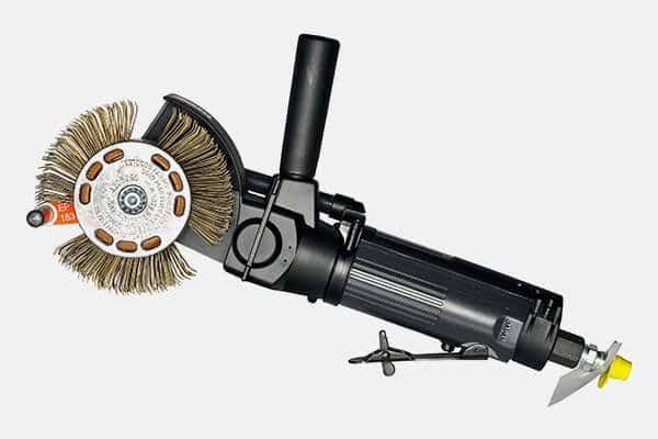 Black pneumatic angle grinder with wire brush and side handle on white background