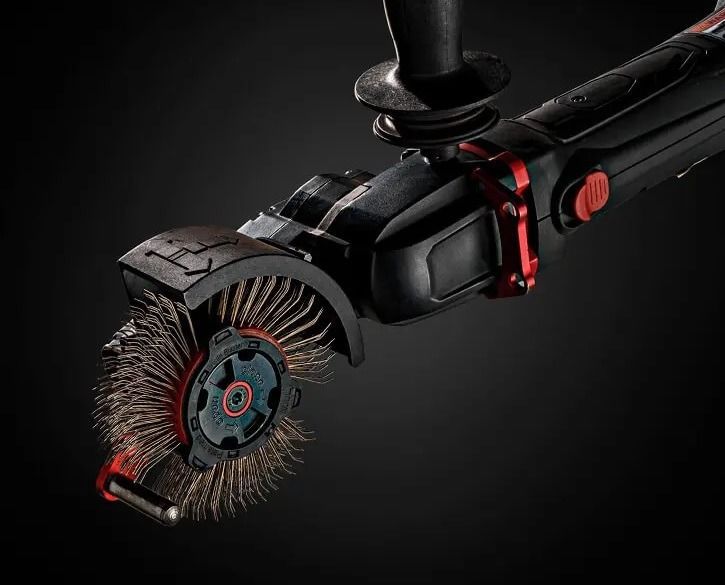Motorized brush tool with rotating bristles and red accents on a black background