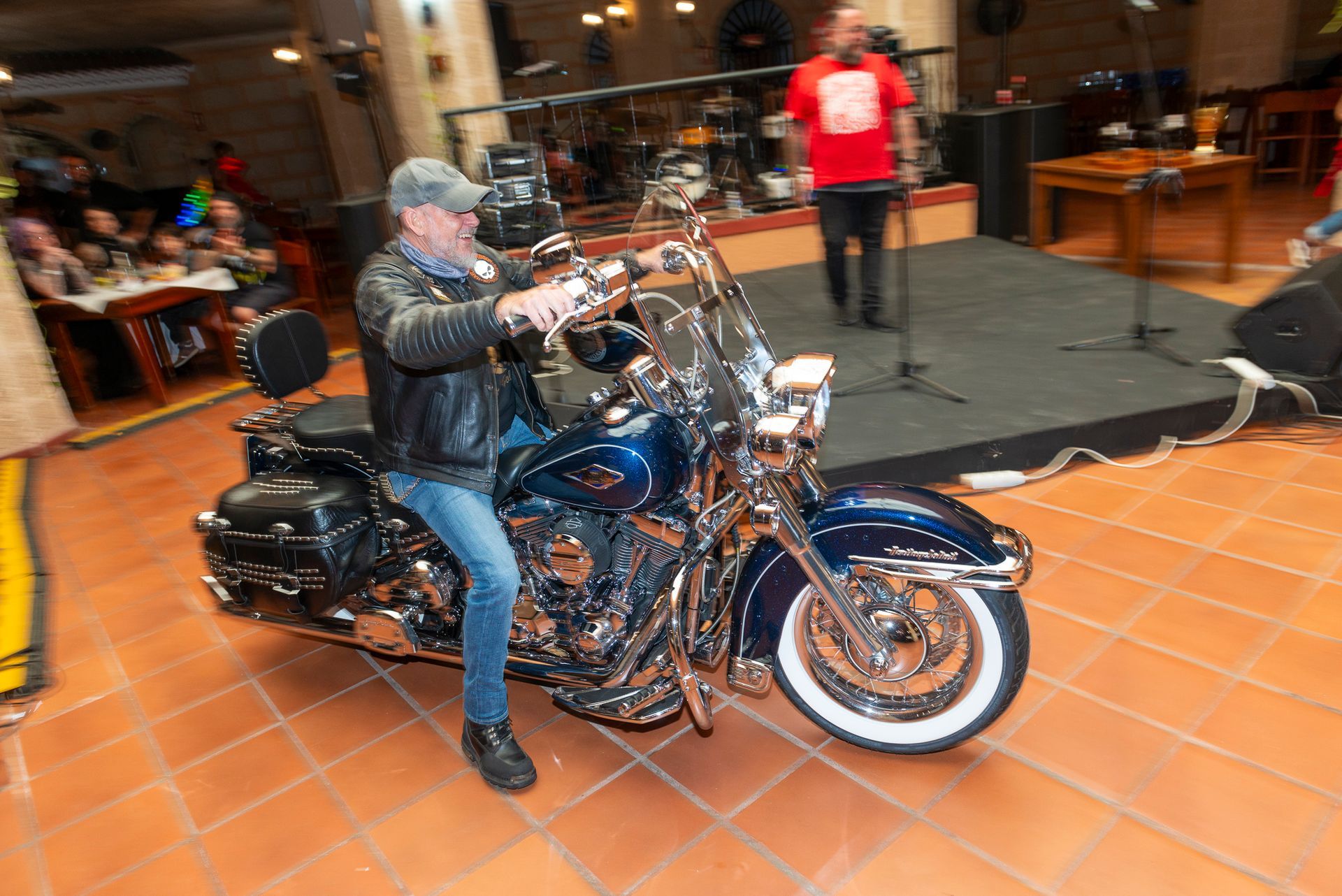 A man is riding a harley davidson motorcycle in a room.