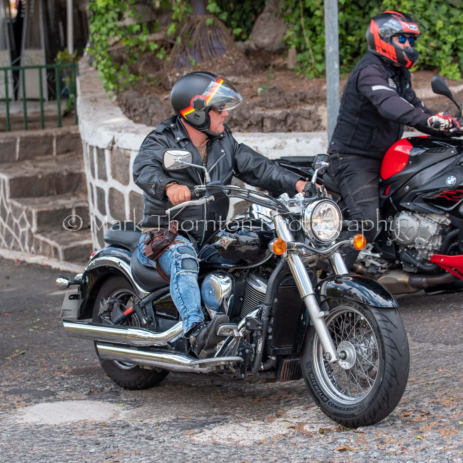 A man wearing a helmet is riding a motorcycle