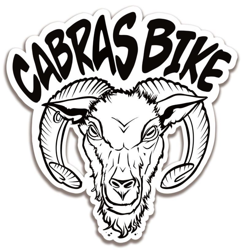 A black and white drawing of a goat 's head with horns and the words cabras bike.