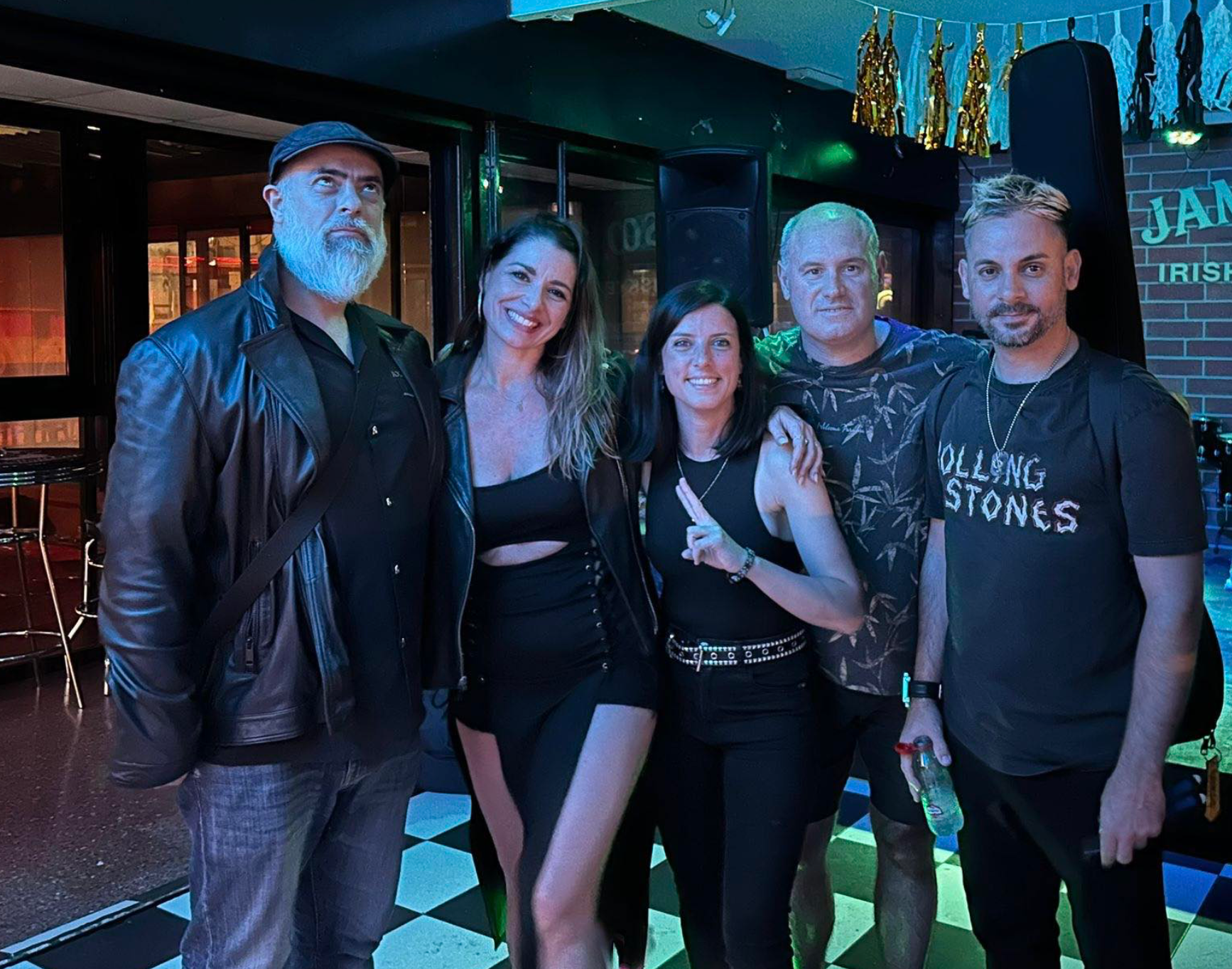 A group of people standing next to each other in a room.