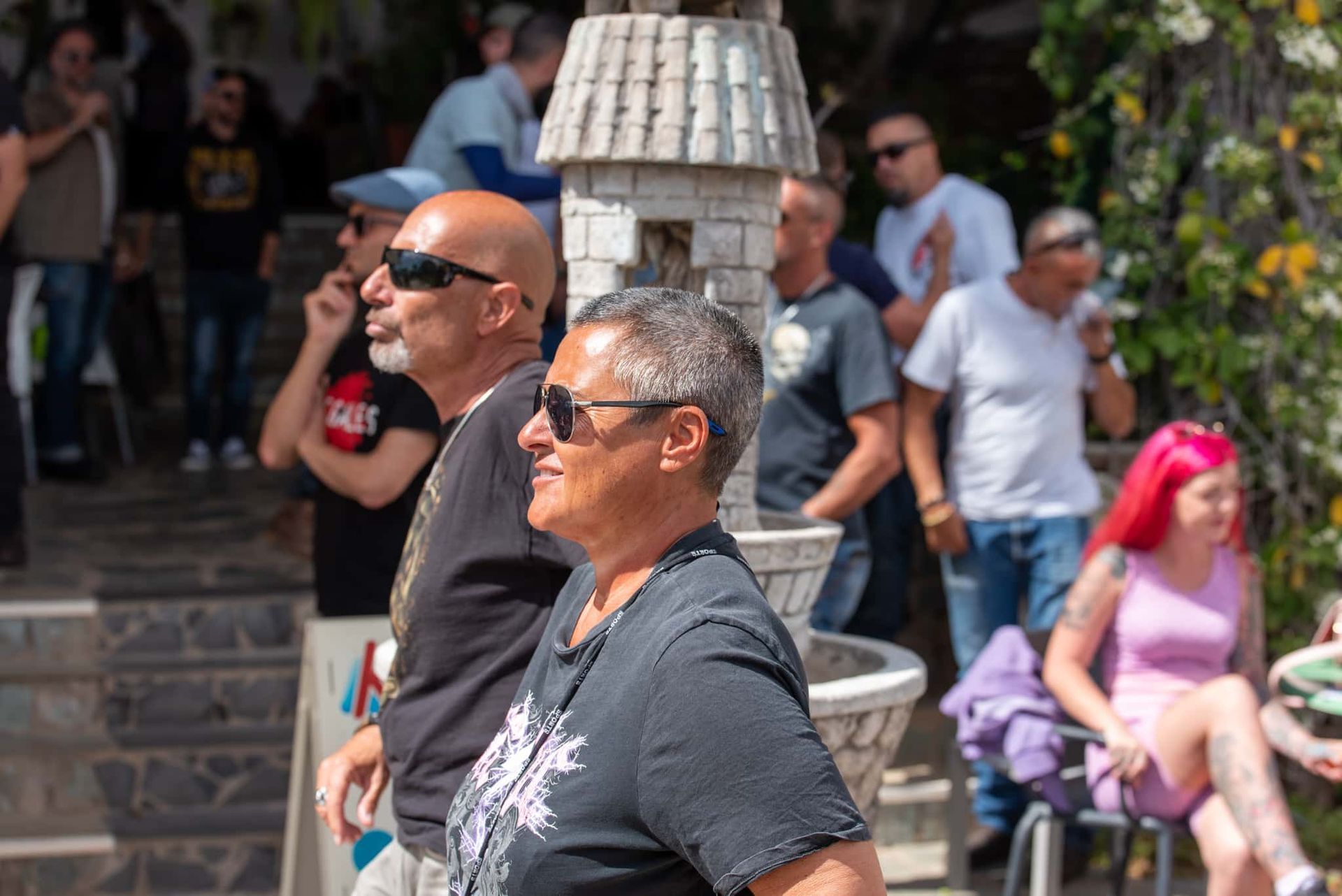 A man and a woman are standing in front of a crowd of people.