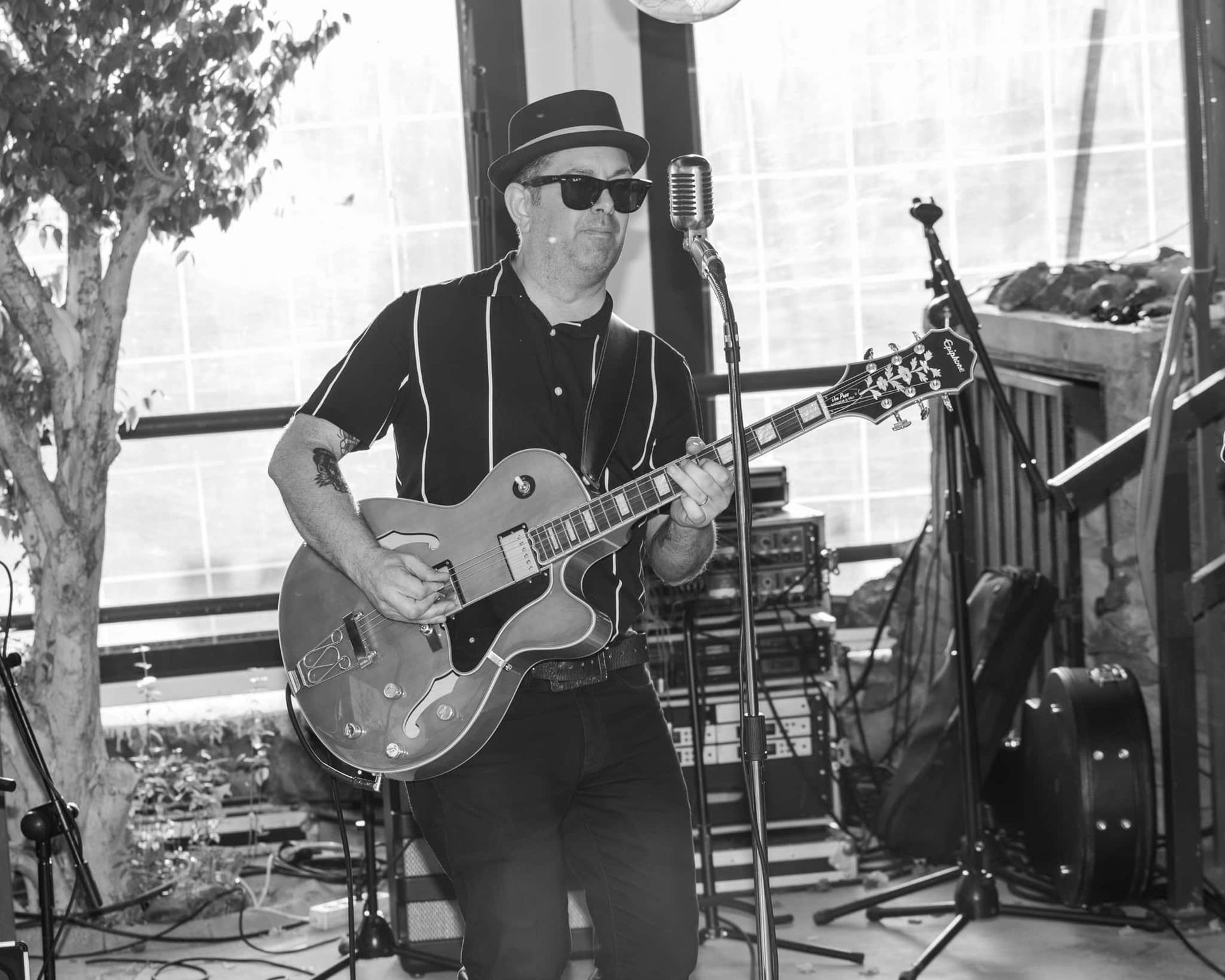 A man is playing a guitar and singing into a microphone