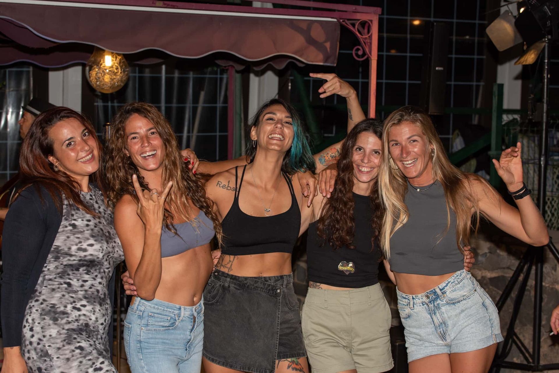 A group of women are posing for a picture together.