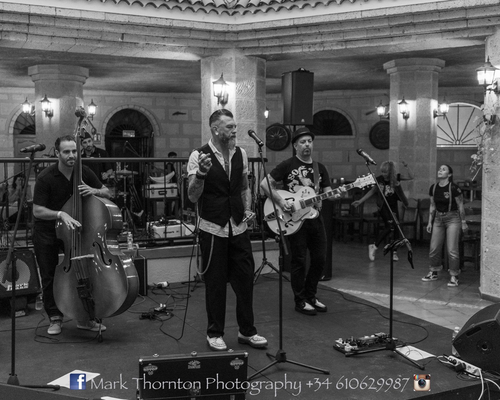 A black and white photo of a band playing instruments